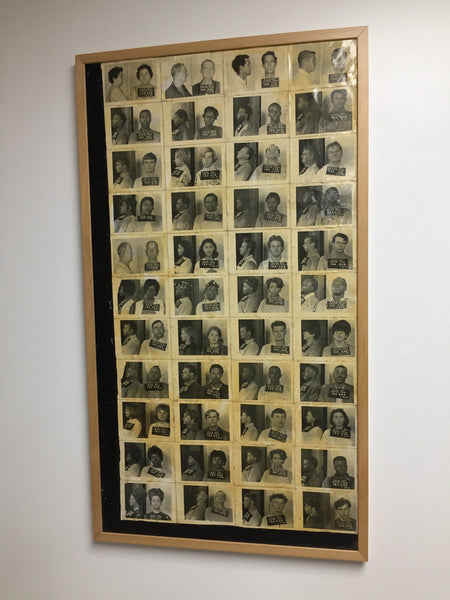 A collection of actual Houston Texas mugshots glued to board and framed