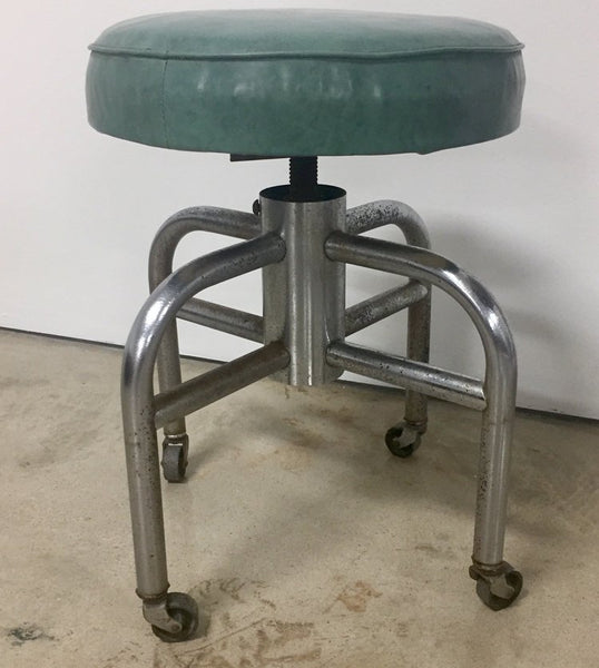 Vintage industrial tubular steel rolling stool and cantilevered table